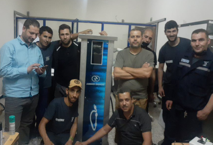 La première borne de recharge entourée de ses concepteurs, de jeunes ingénieurs et techniciens algériens